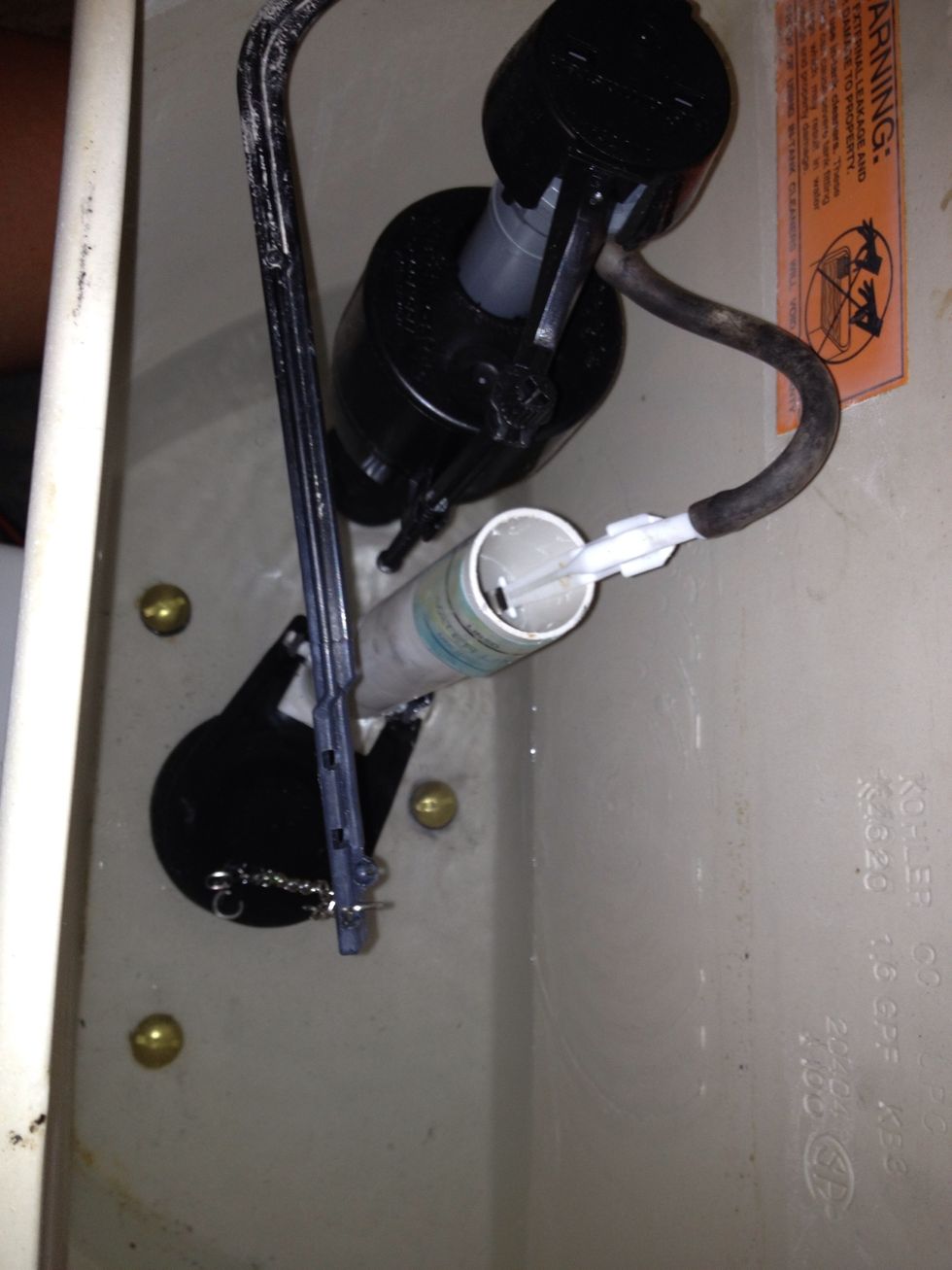 Replace flow valve, attach flapper, chain and secure bolts.