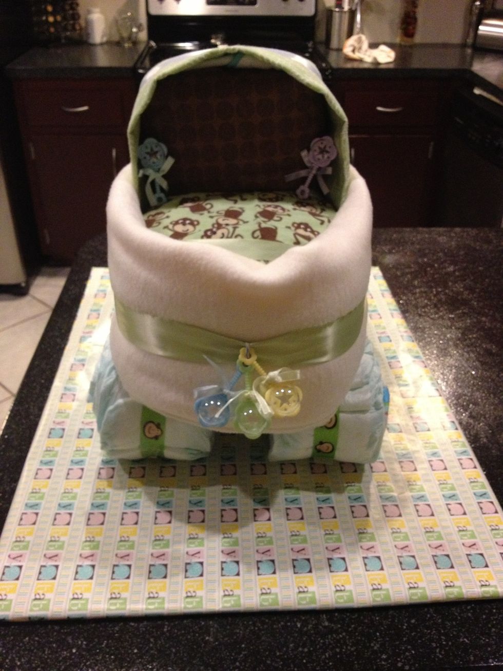 Rest bed on top of wheels and secure below with a ribbon tied to the axel to the ribbon around the bed.