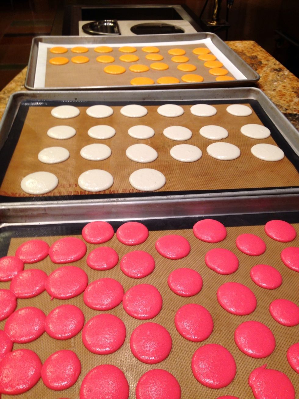 Rest the macarons for about 20 min. They should not feel sticky on top before going into the oven. Be sure to give them enough spacing, unlike we did with ours on the bottom left.