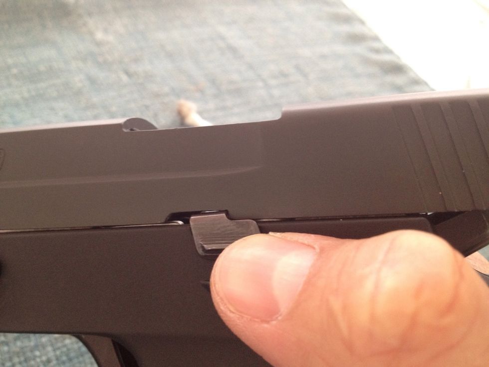 Retract the slide slightly to disengage the slide catch lever. Allow the slide to move forward in a controlled fashion.