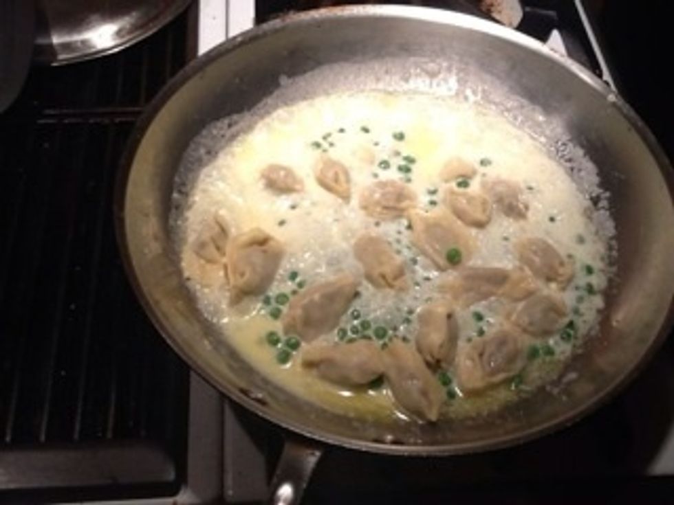 Return pasta to cream/butter and simmer for 2-3 min over medium heat. Remove garlic cloves. Add fresh herb mix an parmigiano off heat