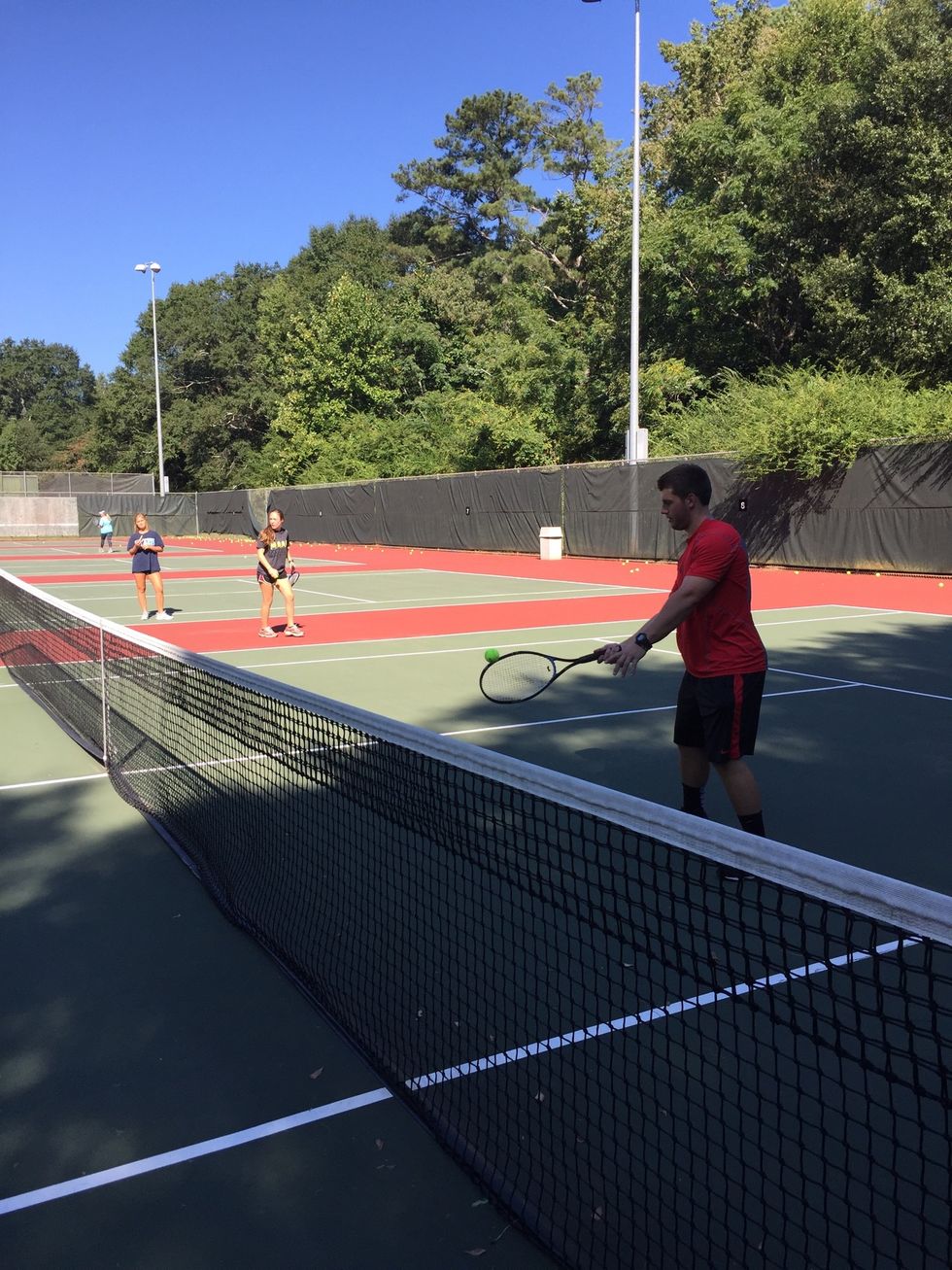 Return the ball back across the net before it hits the ground: your racquet should make contact with the ball slightly in front of you