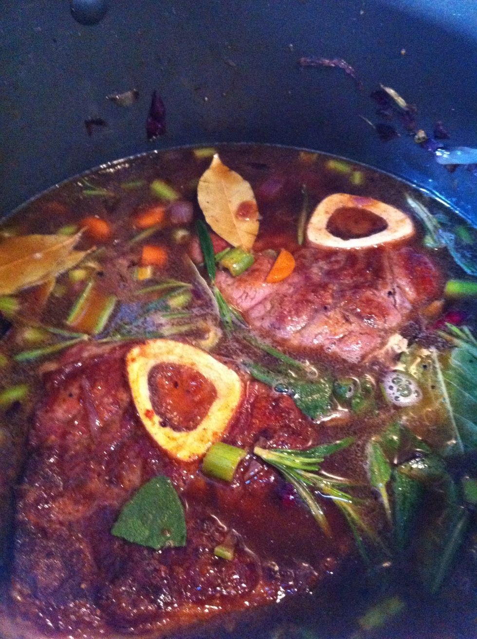 Return the veal to the pan . Add the beef stock rosemary sage and bay leaves put the lid on and simmer for 1h 30 . For the last 30 mins remove the lid and let it reduce a bit. Season to taste