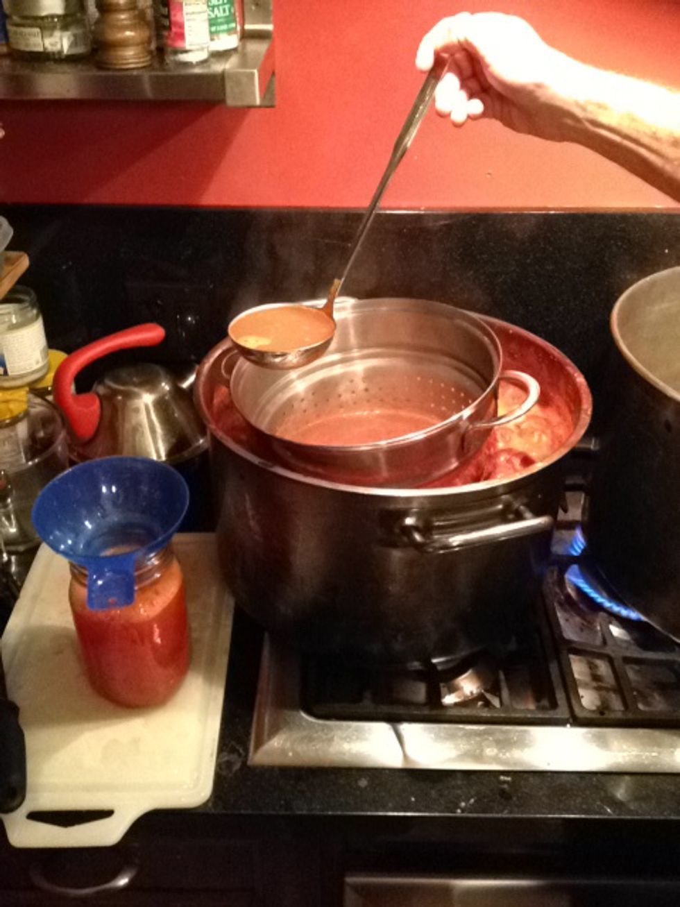 Reveal tomato water by gently pressing sieve, chinois or colander into tomatoes. extract with ladle into jars for canning. Remove more than necessary, you can always add back later.