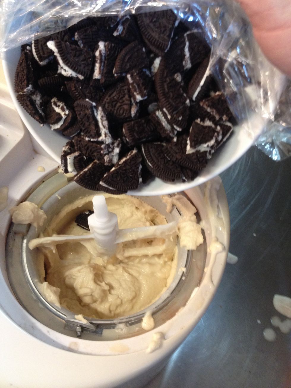 Right as it's nearing completion, add the Oreo pieces. Let the ice cream churn for a minute or so (til pieces are incorporated).