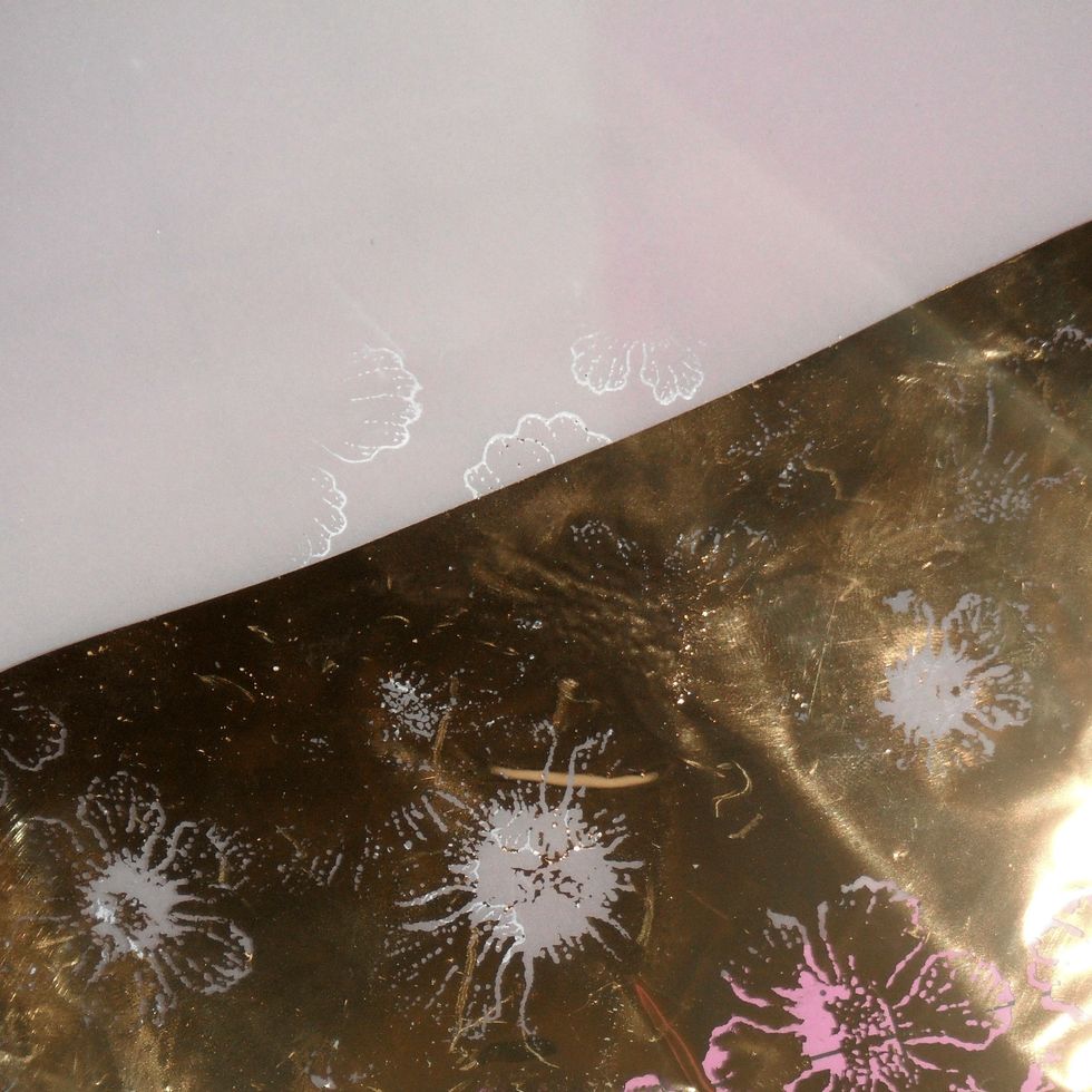 Right away, place a sheet of Decofoil to the stamped image, pressing and burnishing it well.