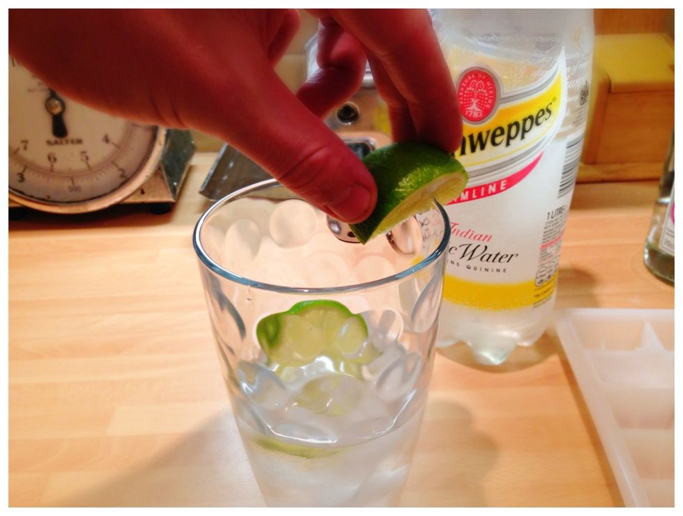 'Rim' the edge of the glass with the lime. Really make sure all the rim is covered in fresh tangy lime