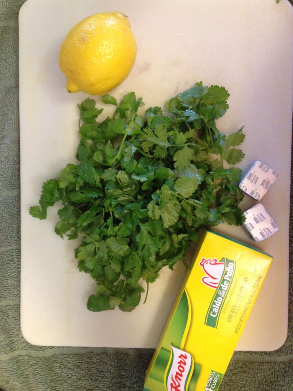Rinse 2 handfuls of fresh cilantro leaves and juice 2 lemons. Unwrap chicken cubes and chop them up a bit so the granules disperse well in the sauce.