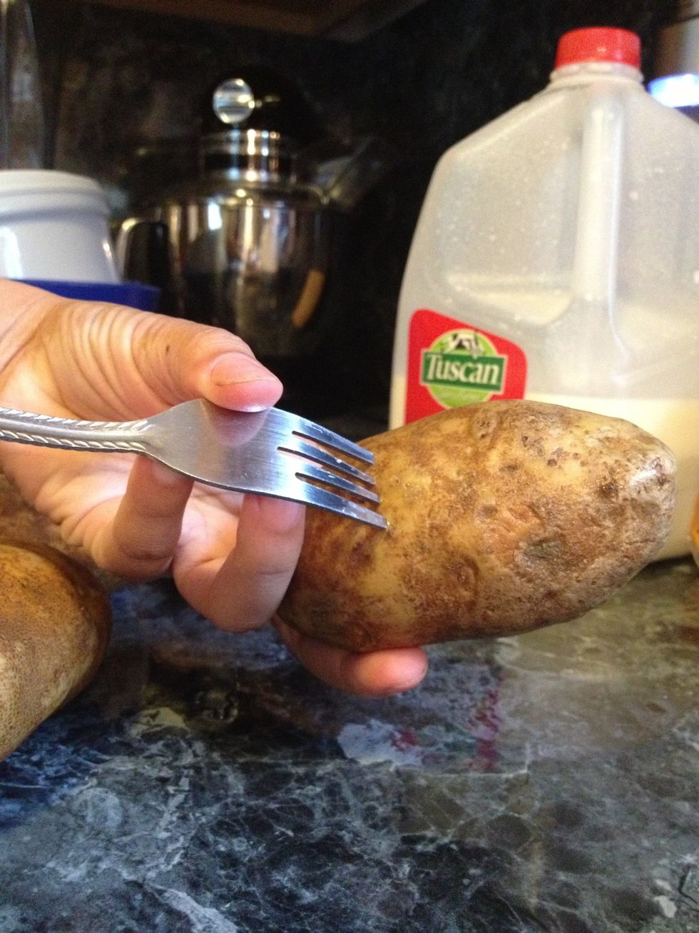 Rinse and scrub your potatoes well with cool water.Dry them well. Remove any bruises with a knife and Poke some holes using a fork in several places.