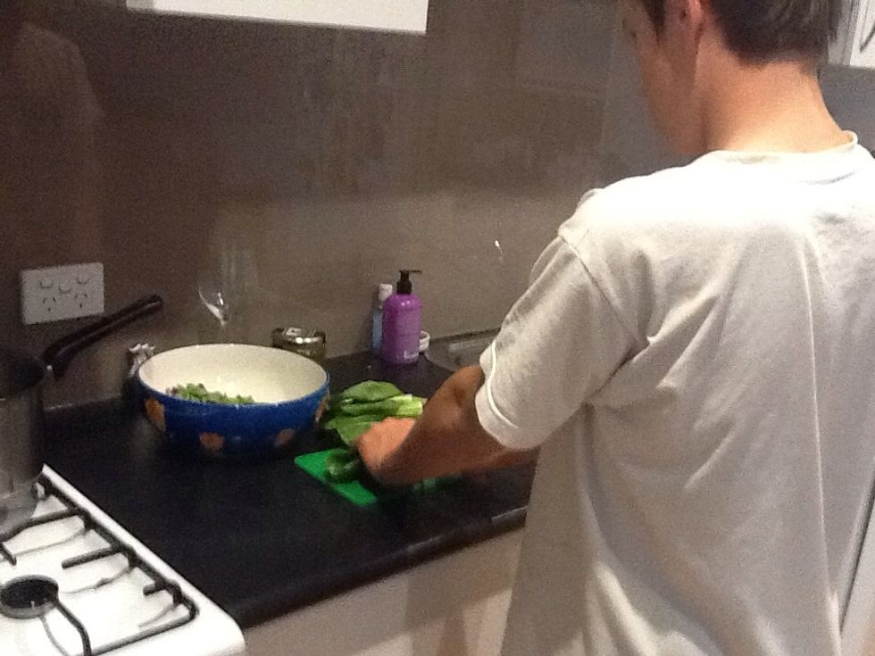 Rinse and slice the woody end bits off the Bok Choi  Then slice in half and separate leafy bits and woody bits