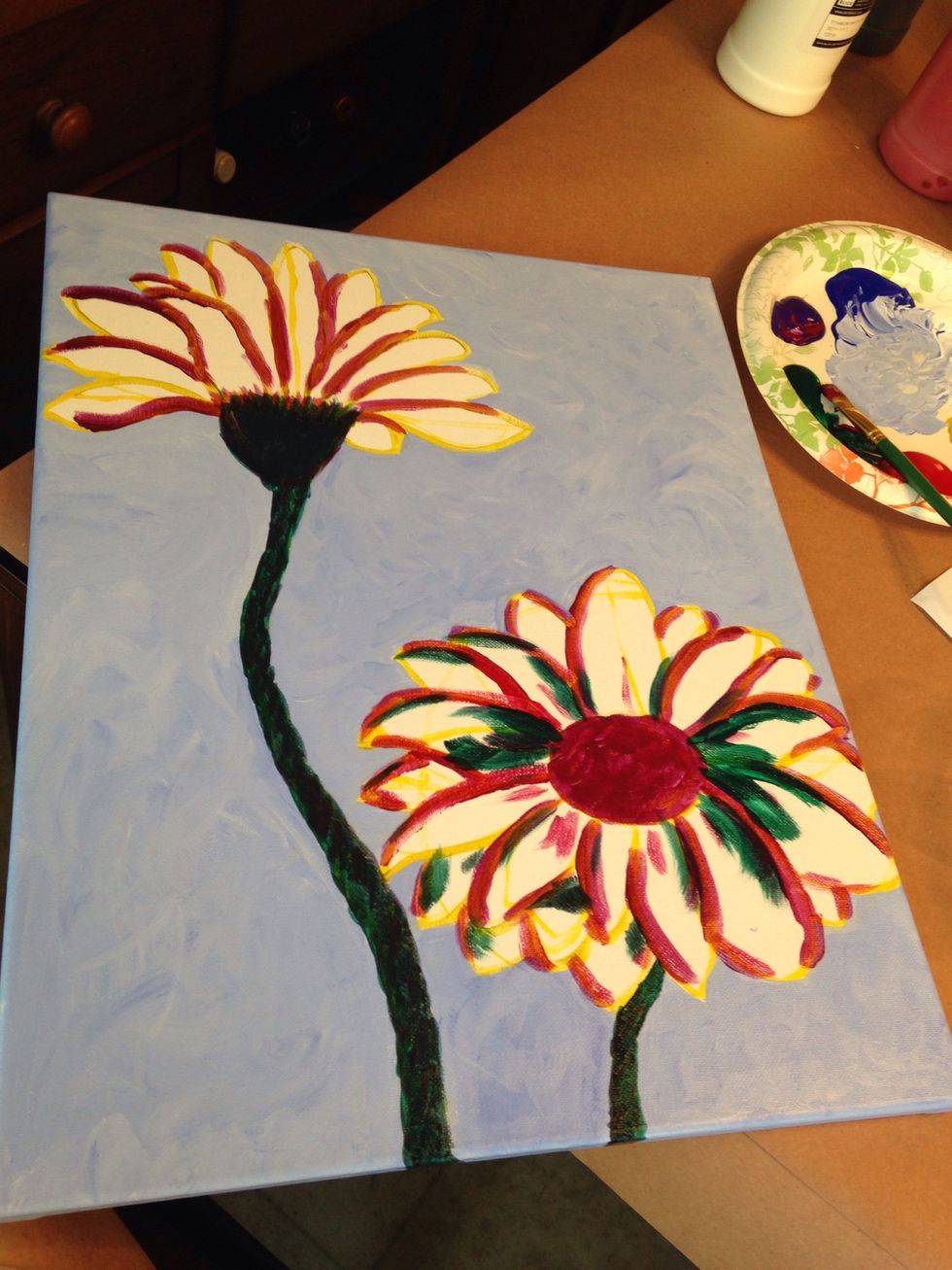Rinse flat brush and dry on paper towel to remove any traces of white paint. Use red, green, blue and purple to outline sections of the flowers and color the stem.
