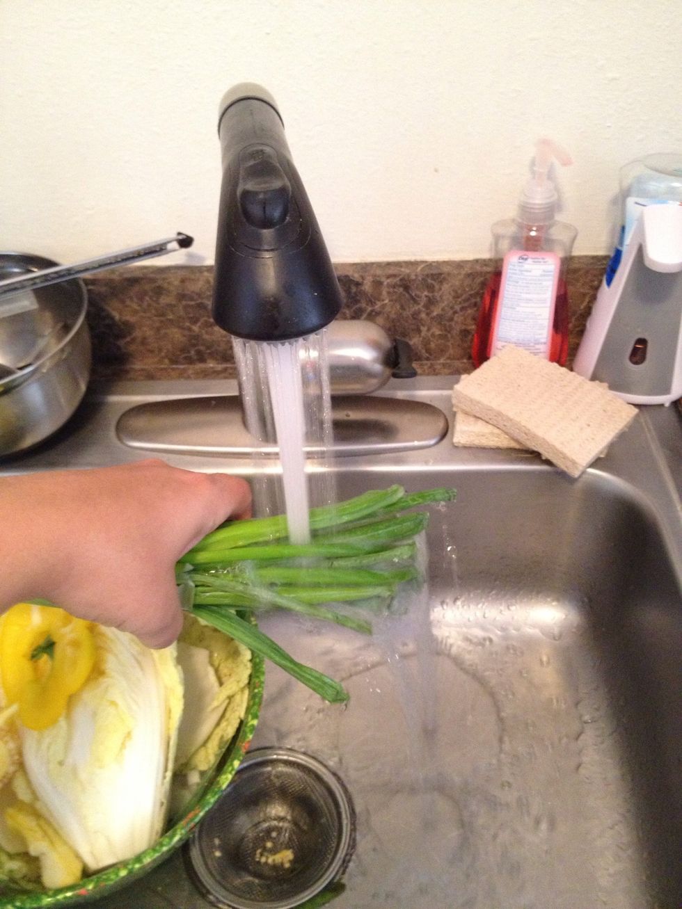 Rinse green onions under cold water.