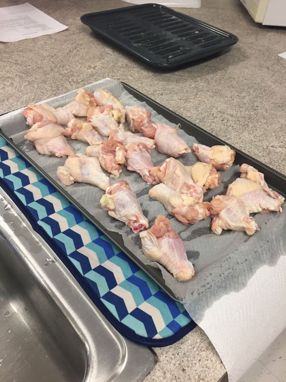 Rinse off the chicken and lay them on a cookie sheet with a paper towel