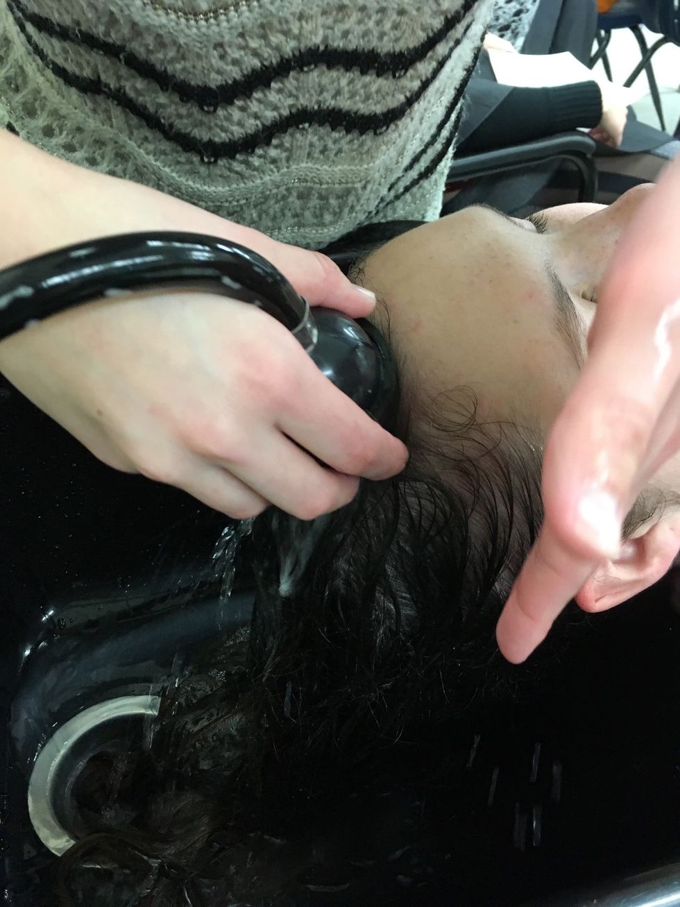 Rinse out shampoo, make sure to protect clients face