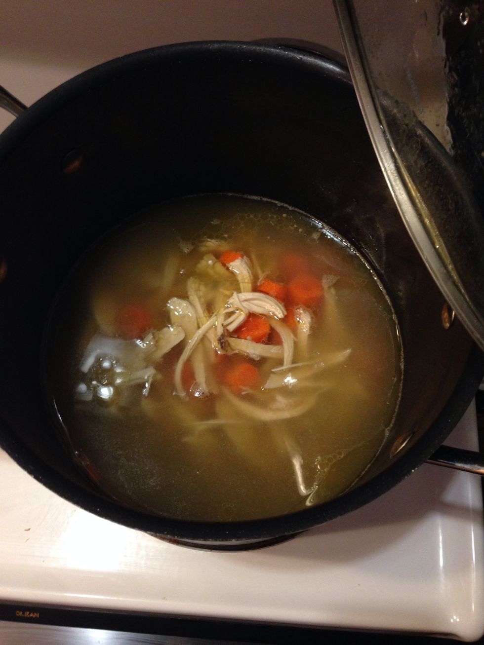 Rinse out the stock pot and put the broth back in it. Pull apart the chicken breasts into small strips and add it to the chicken broth. Save the rest of the chicken.