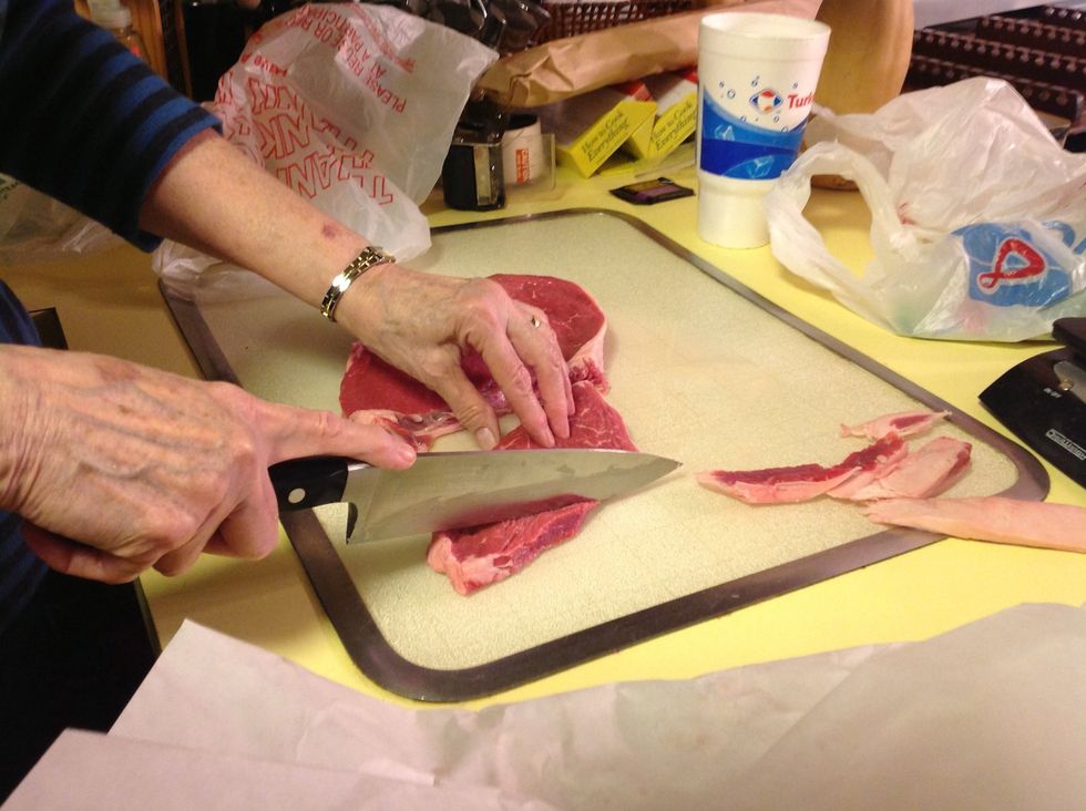 Rinse steaks and trim fat