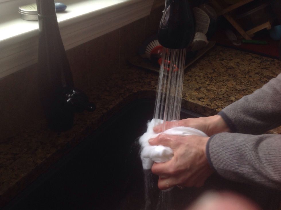 Rinse t-shirt with warm water and basic dish soap.