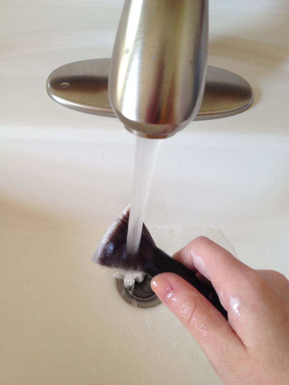 Rinse the brush under warm water. Make sure you get as much shampoo out as possible.