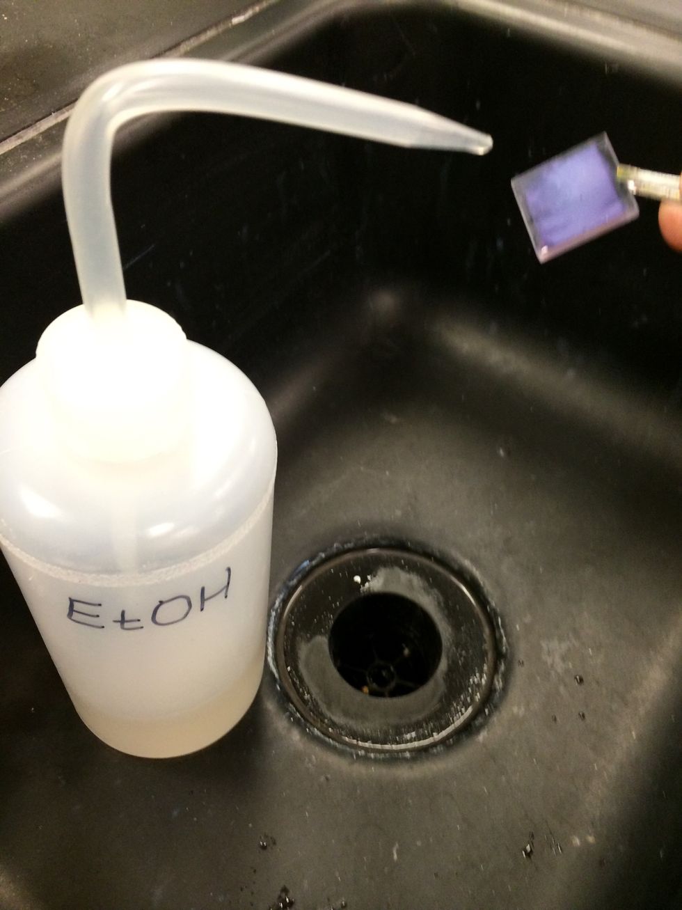 Rinse the slides in water, then in ethanol or isopropyl alcohol.