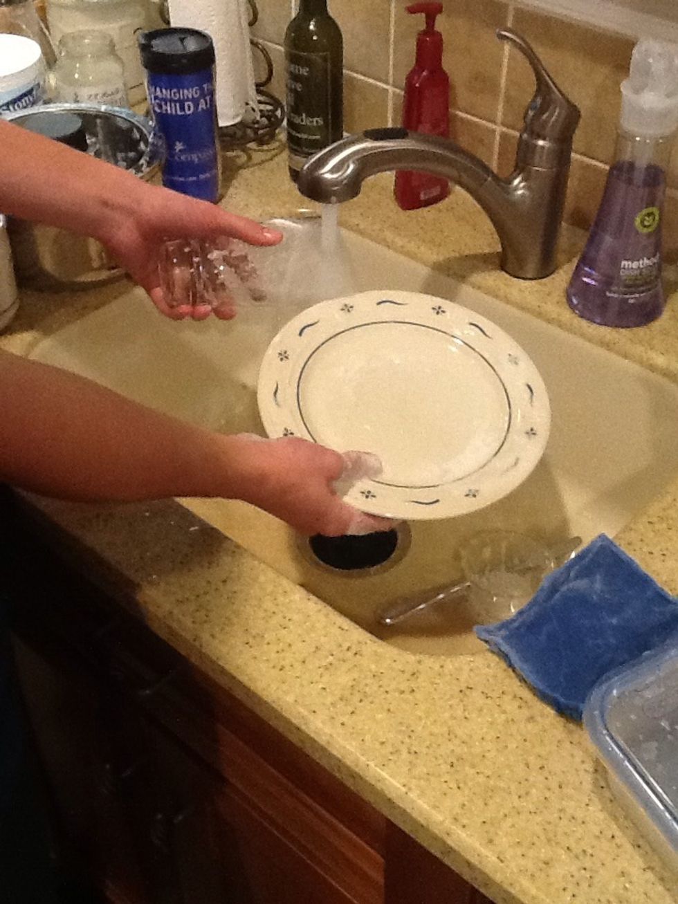 Rinse the soap off the dishes with water.
