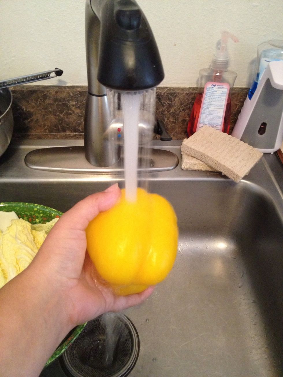 Rinse yellow bell pepper under cold water.