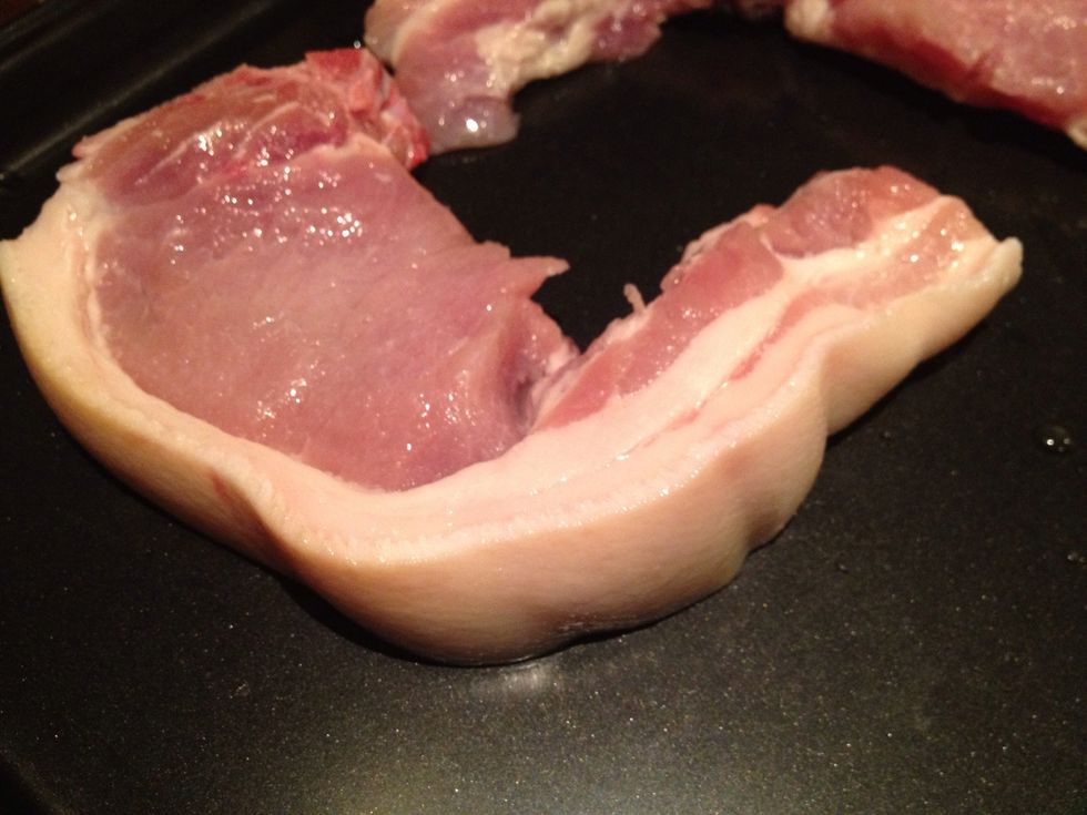 Rinse your pork chops with water and pat try with a paper towel, then and lay them on an oven tray