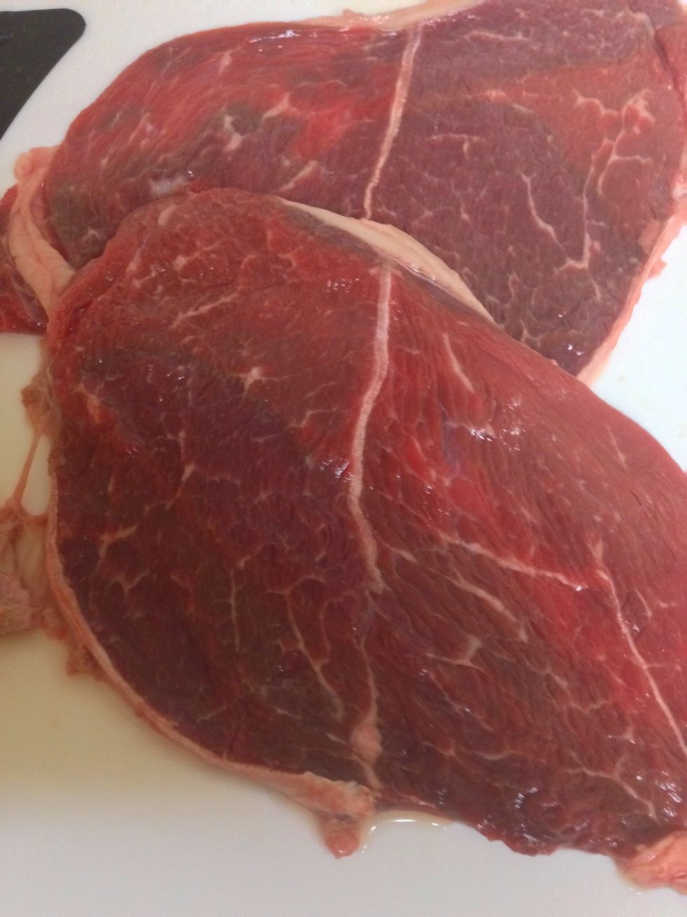 Rinse your steaks thoroughly. Today I used thin sliced beef chuck, as I didn't want a heavy meal. This technique works for all cuts of steaks. It keeps the meat moist & cooks the seasons into it.