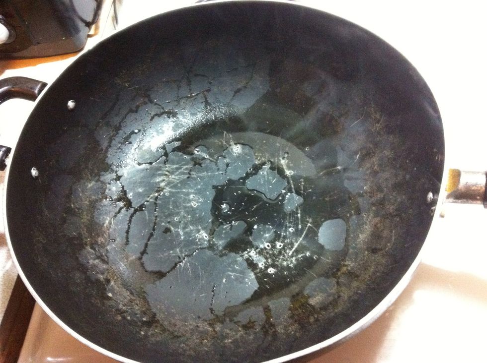 Rinse your wok and let the burner heat up the pan to clear out the water in the wok.