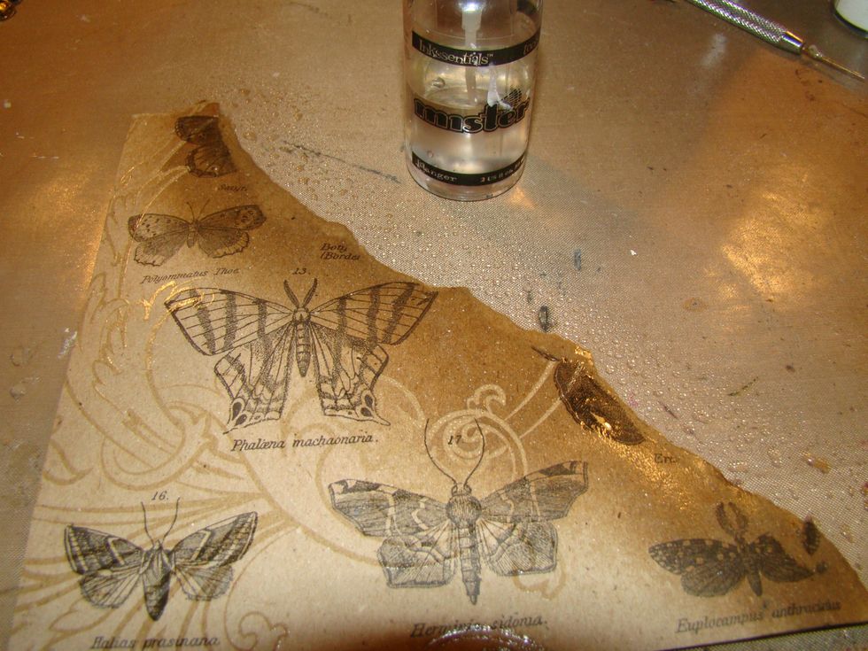 Rip a piece of your "Paper Stash" for the bottom corner of your canvas. Mist your paper with water to break down the fibers a bit so you can rip and roll the edges easier.