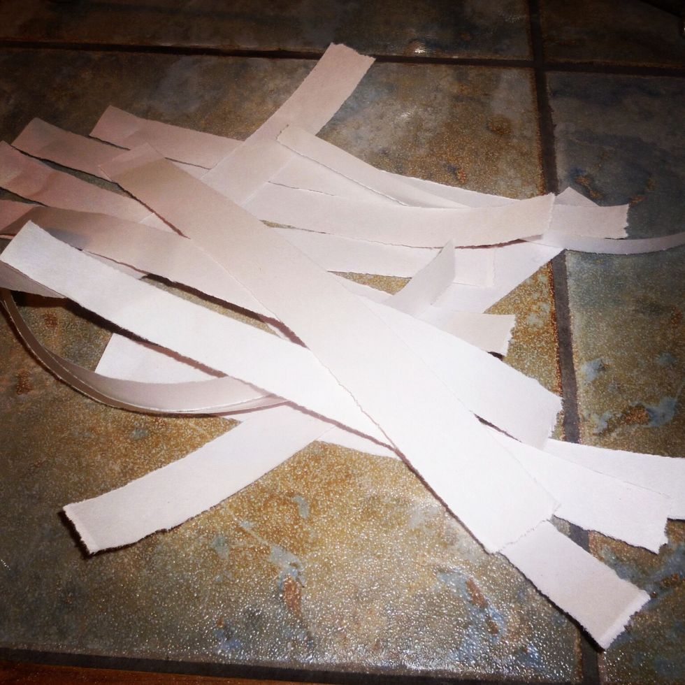 Rip strips of paper. This is our base that we will use as a canvas to paint & decoupage on. I used strips of newsprint paper.