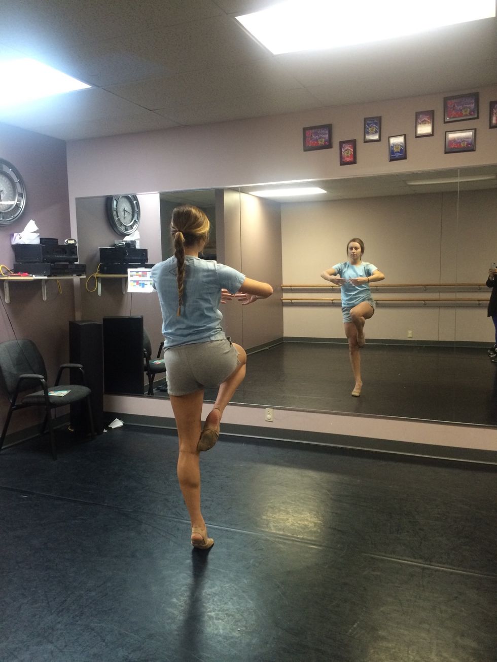 Rise up to only the ball of your left foot. Bring your left arm in to meet your right in front of you. Round them as if you are holding a beach ball. This is what will give you power to turn.