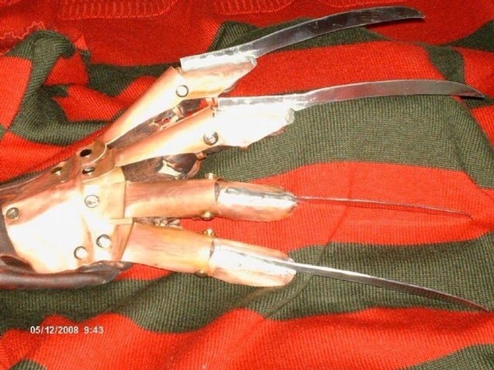 Rivet the stalls to the backplate, then cut the leather glove to age it, and rivet the whole armature to the glove. Again, test the armature on your hand to see where the holes in the glove go.