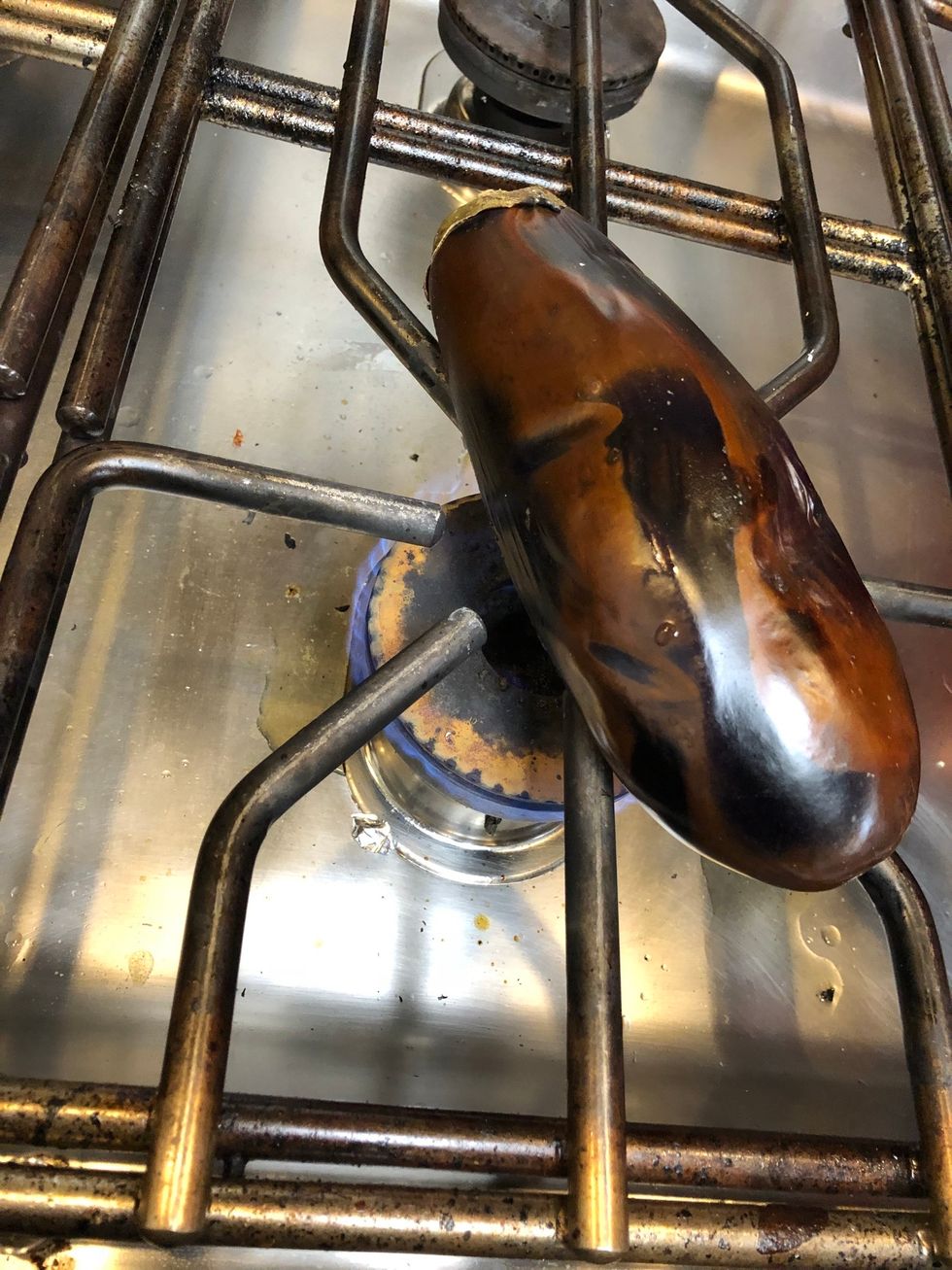Roast eggplant over a flame.