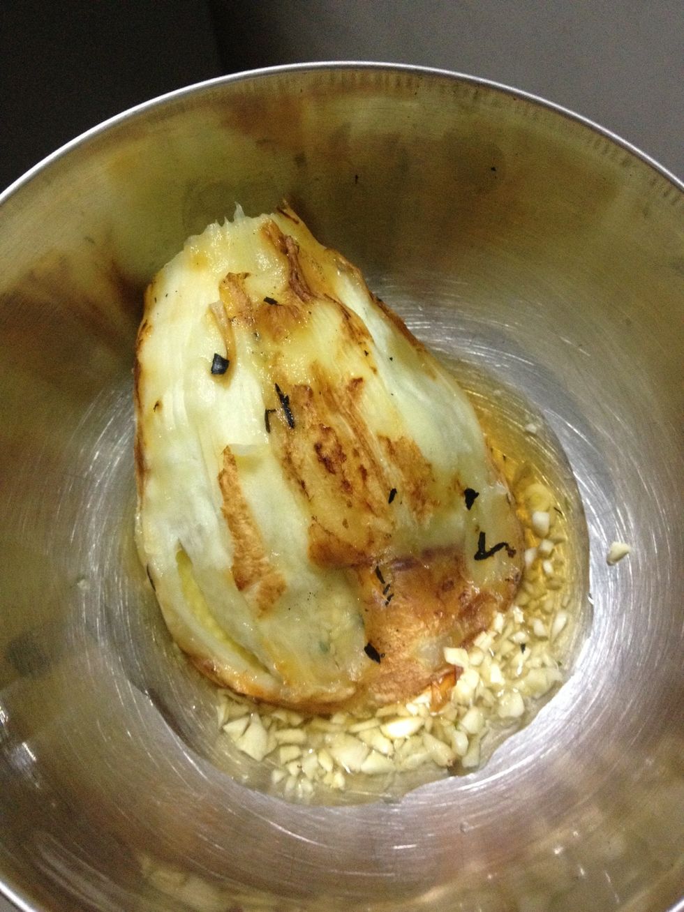 Roast the egg plant on flame till soft inside and peel off the charred skin and mix with mince garlic