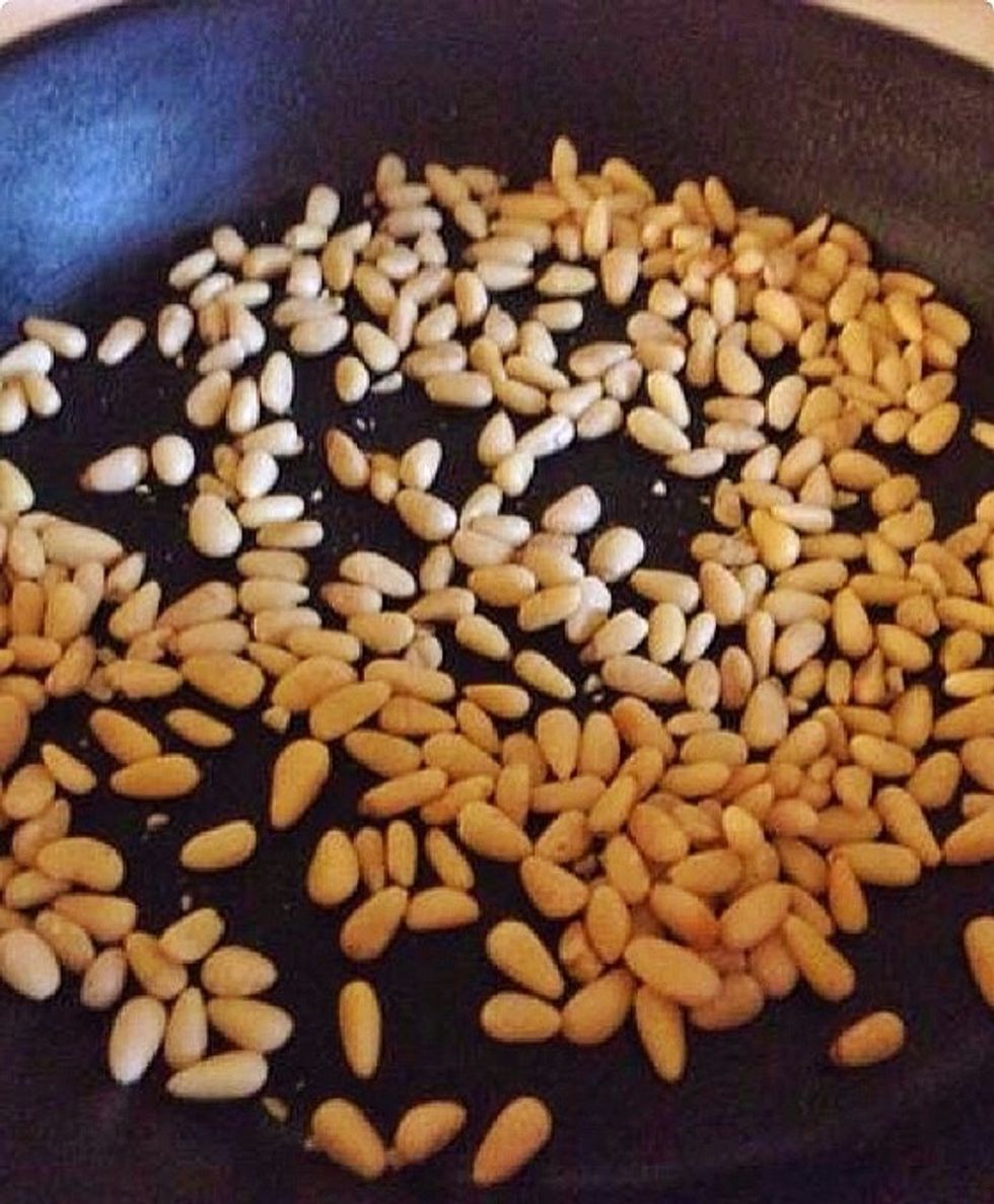 Roast the pine nuts in a skillet.