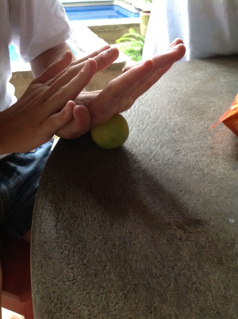 Role lime with your hands on the table