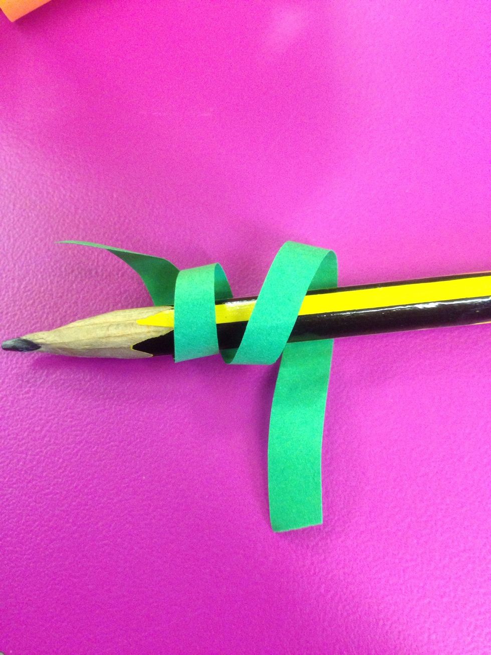 Roll a couple of thin strips of green paper around a pencil.