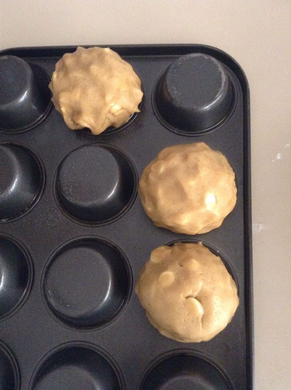 Roll a good amount of dough in your palms into a ball, then place it in the middle of the lump. Spread the dough down the side of the lump depending on how deep you want your cups.