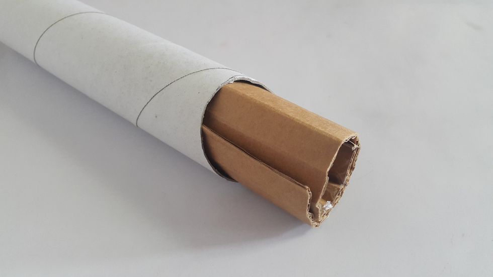 Roll a piece of cardboard, put into the kitchen tissue roll, cut the excess