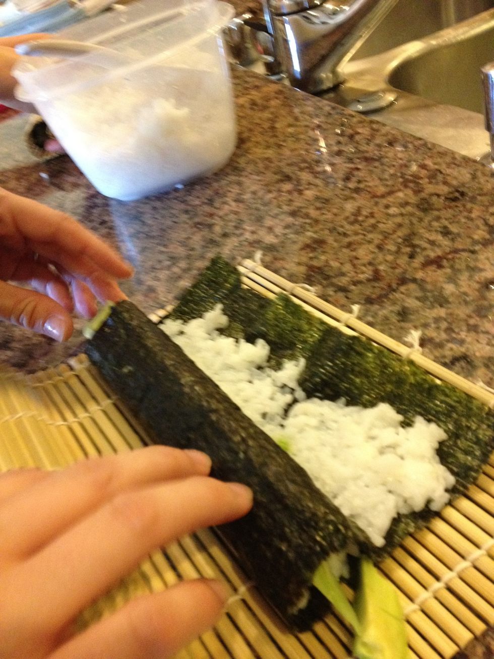Roll back the mat and finish rolling the sushi with just your hands. Then form the mat around the fully-rolled sushi to pack it tighter\u2014otherwise the insides will fall out while being cut!