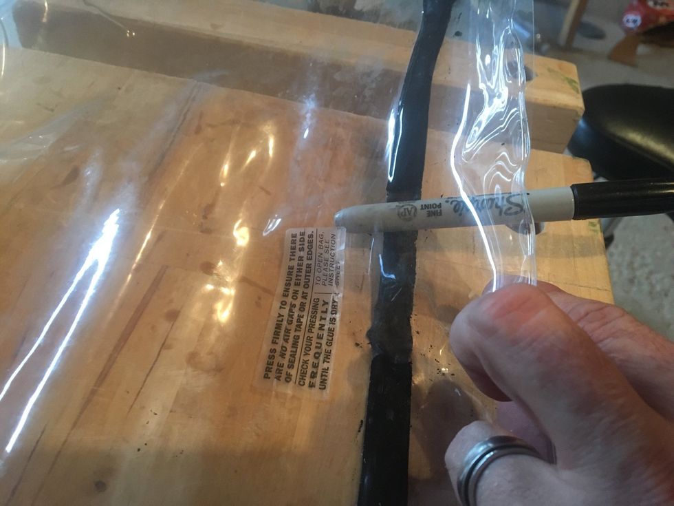 Roll blunt object along sealing tape until vacuum bag is open.