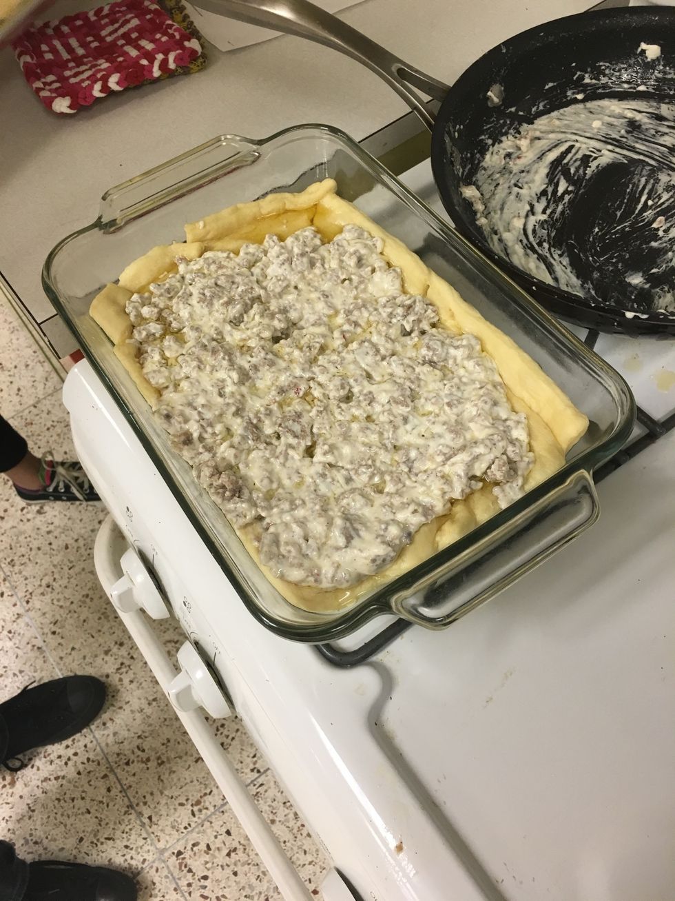 roll dough onto pan then add sausage mixture