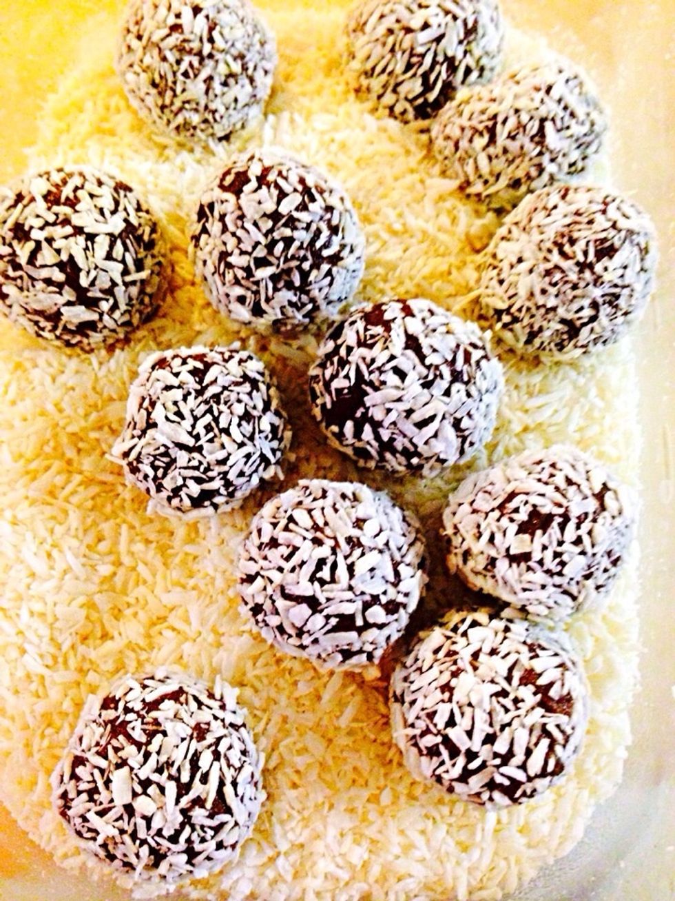 Roll each ball in coconut flakes. You can make them more interesting by rolling in different toppings such as: ground walnuts or any nuts, ground graham crackers, colored sugar, ground cereal