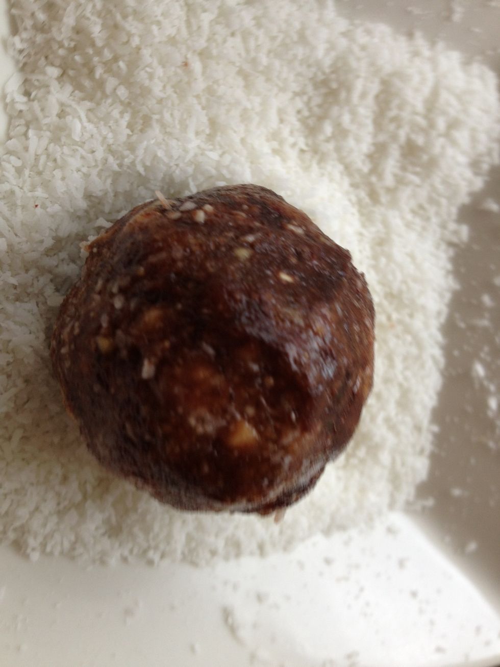 Roll into a smooth, bite size ball. Roll in a small bowl of desiccated coconut.