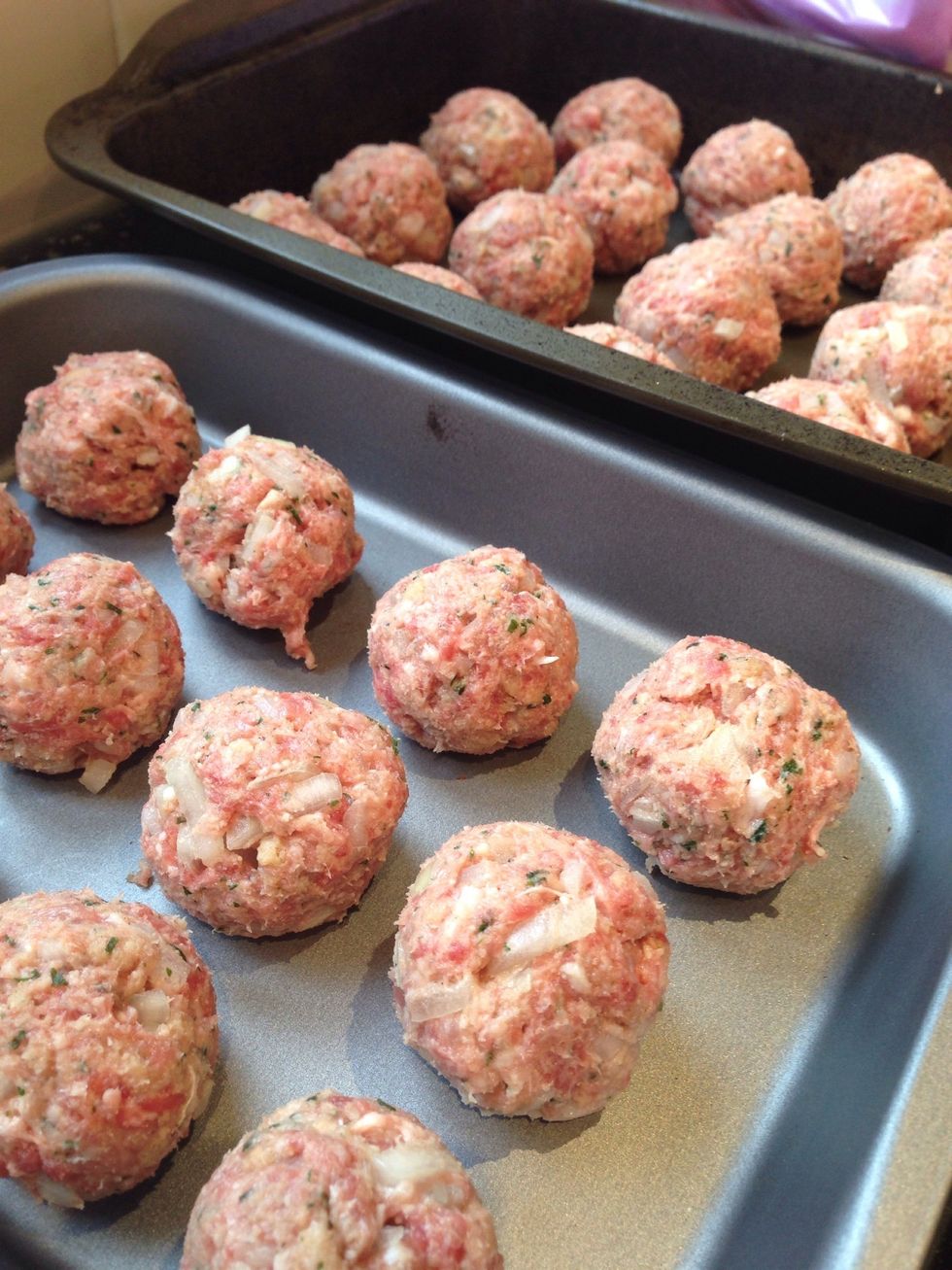 Roll into balls about the same size as a golf ball. And lay out on trays. If you are freezing any meatballs put them in the freezer now. Once frozen they can be put in plastic food bags