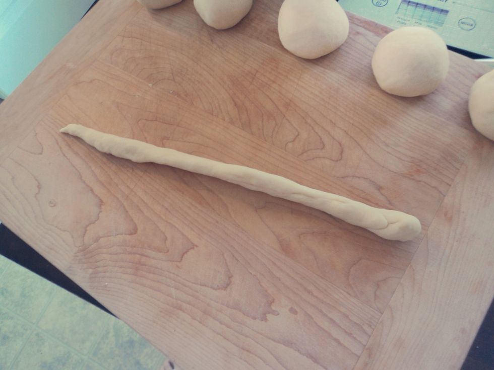 Roll into long strips, one end slightly larger than the other.