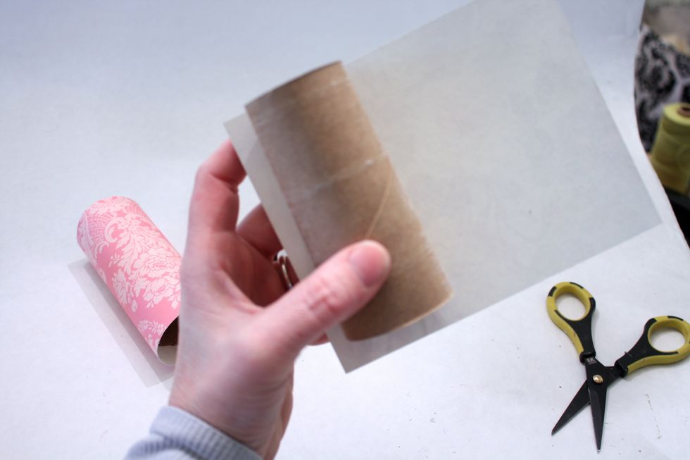 roll it around the tube- line it up as straight as possible, you should match at the top and have the extra hanging over the bottom (the 6 inch side goes around, the 5 inch up and down)