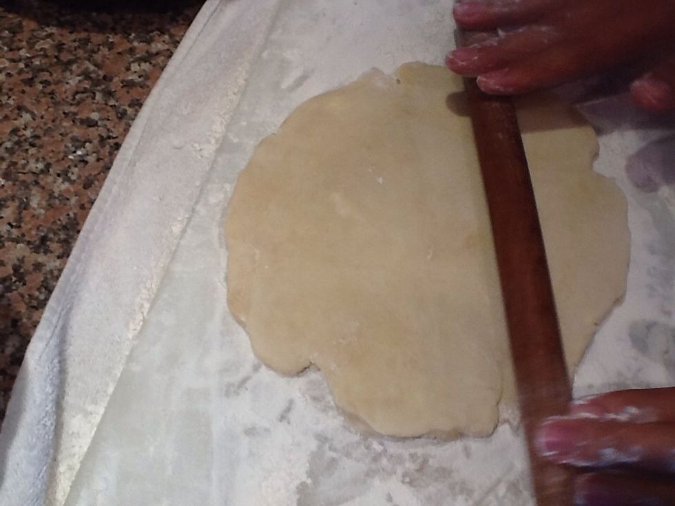 Roll it out. Be patient during this process. Roll it a couple times in one direction and then rotate it a bit and repeat until you've rolled out your dough into 12 inches in diameter.