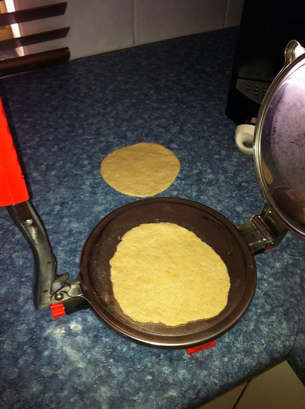 Roll it to about 8-10cm In Diameter. Alternatively use a poori press as shown in this photo. Make sure there are no holes in the poori