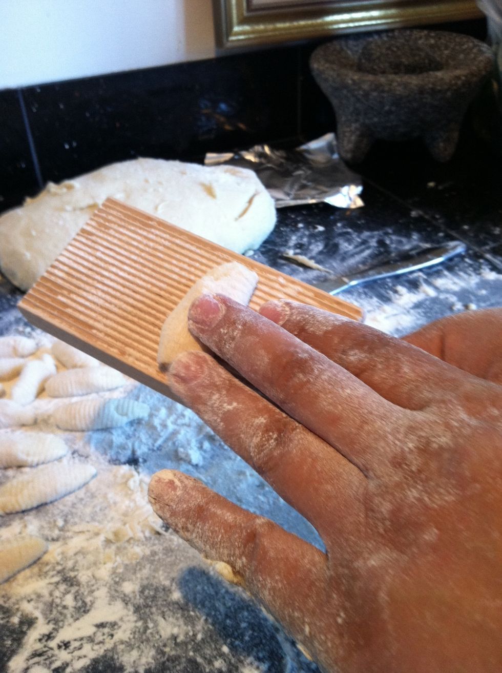 Roll on gnocchi board ($5 on amazon) using 3 fingers putting more pressure on outside two fingers.
